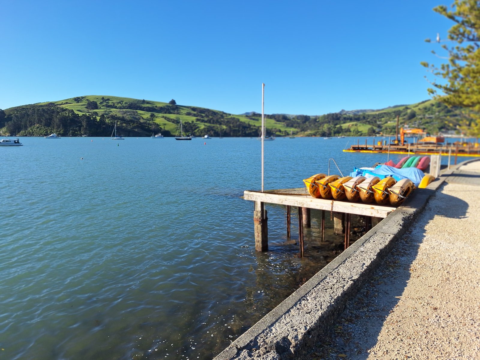 Harbour stop with kayaks and hills across the water.